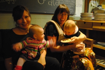 Two women and their babies smiling